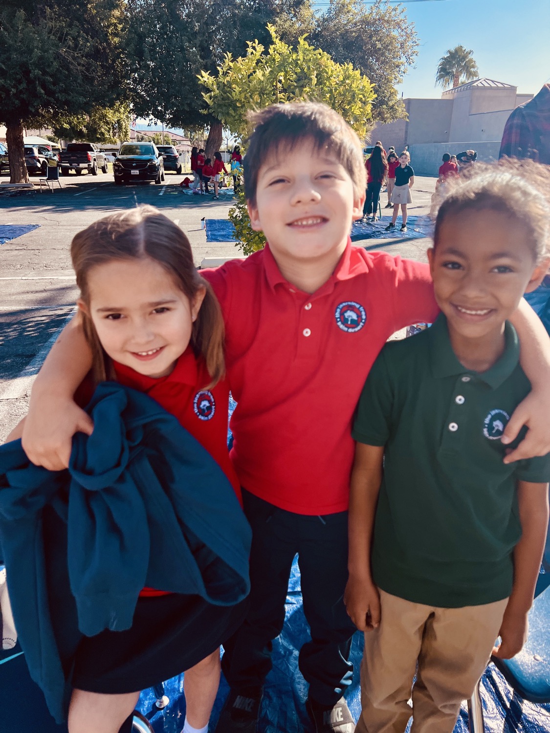 Learning Tree students with their arms around each other outside on campus