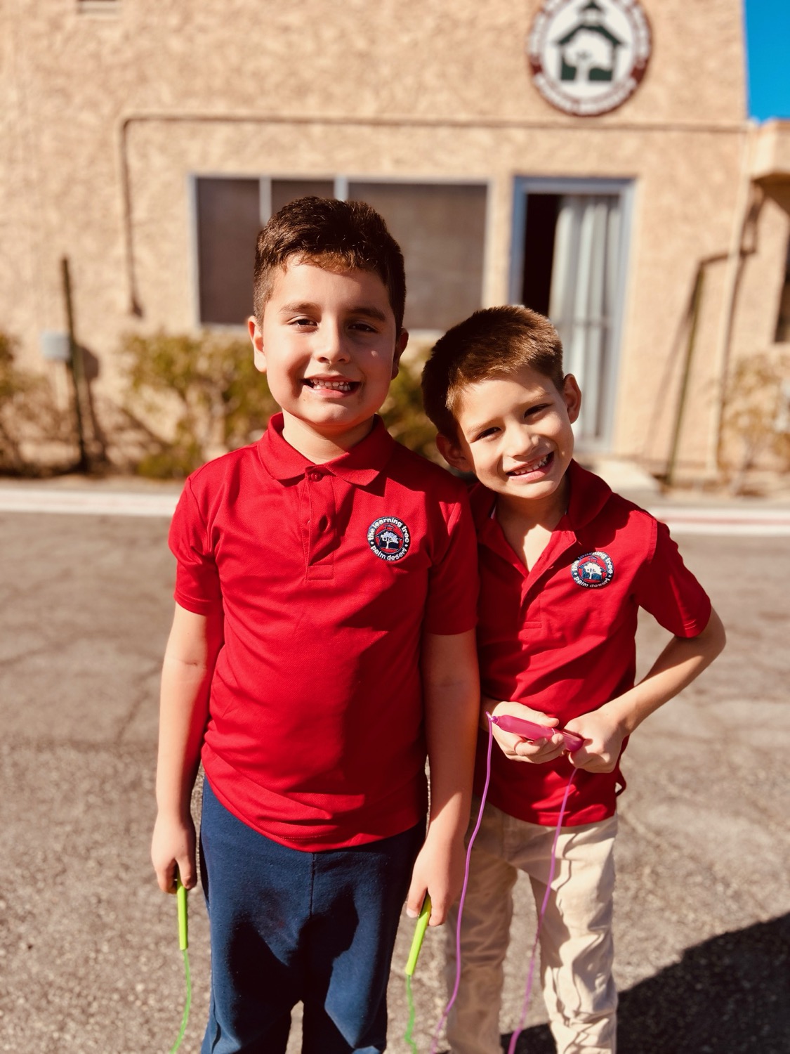 Two Learning Tree students in uniform outside the school building in Palm Desert