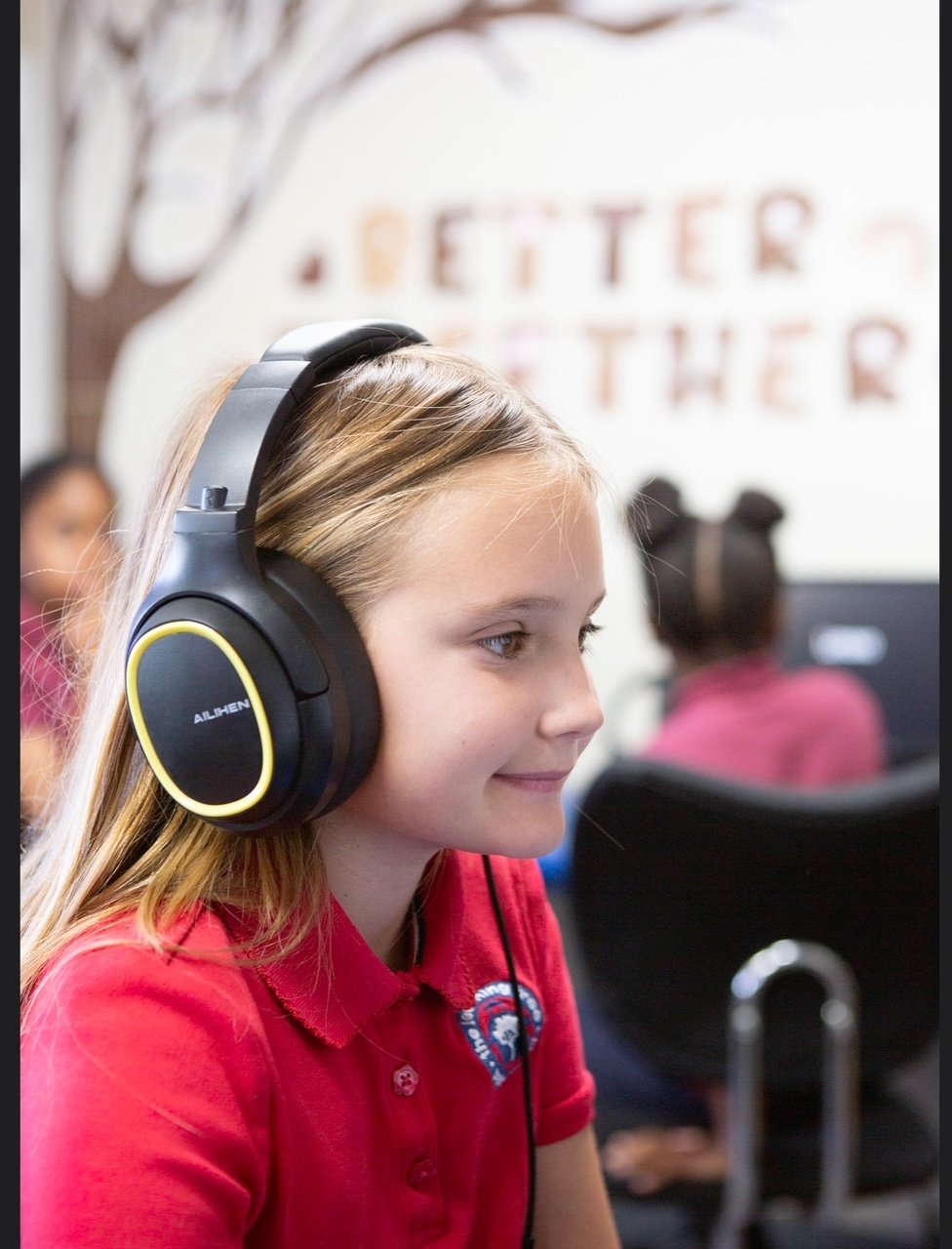 A Learning Tree student learning with headphones at a computer