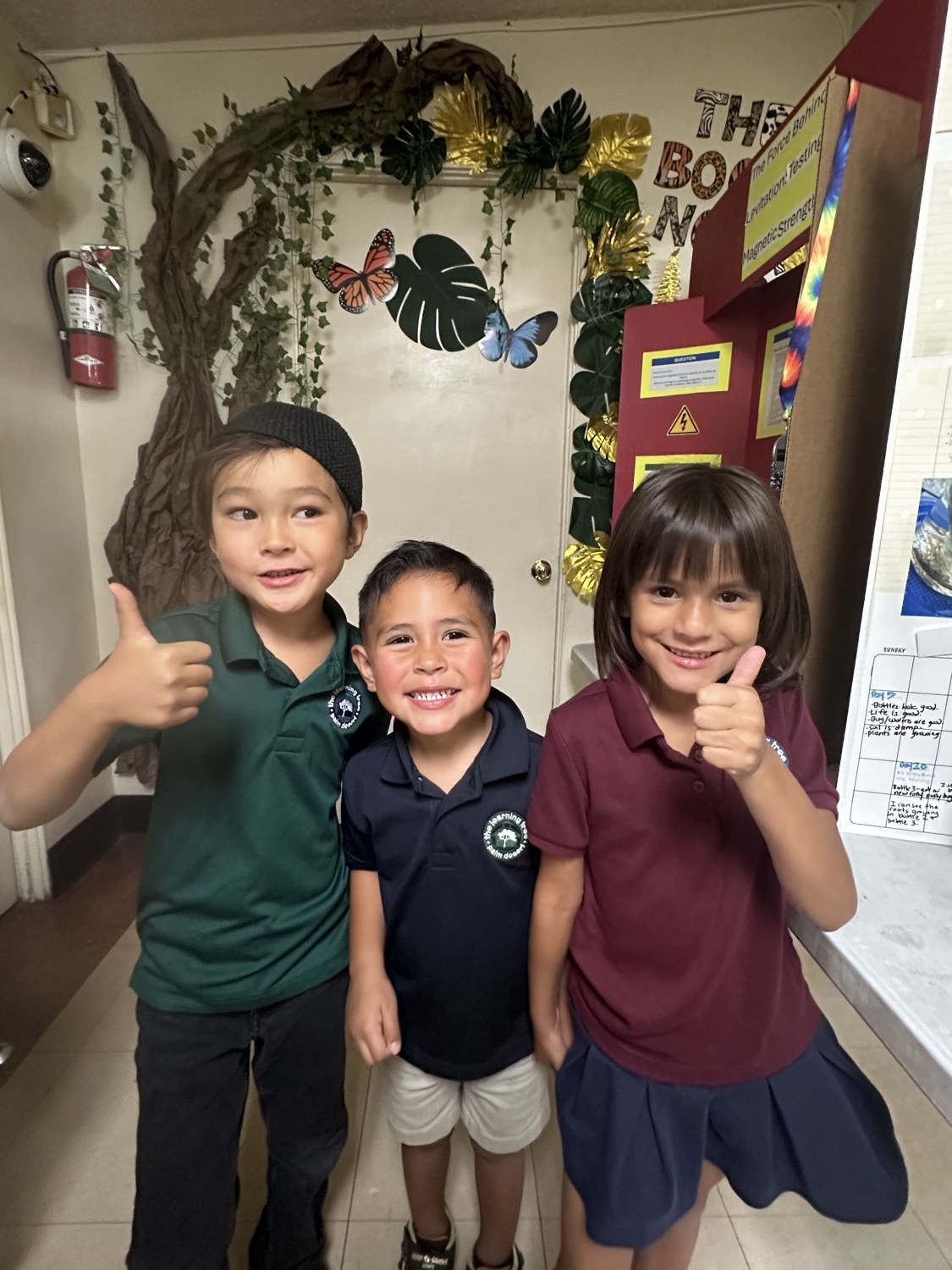Happy children giving a thumbs up at The Palm Desert Learning Tree Center in the Coachella Valley